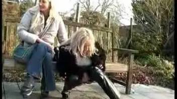 Lady pissing near the bench