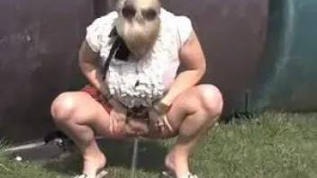 Chick piss sat on a green lawn