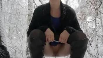 Amateur video pooping girl in the winter forest